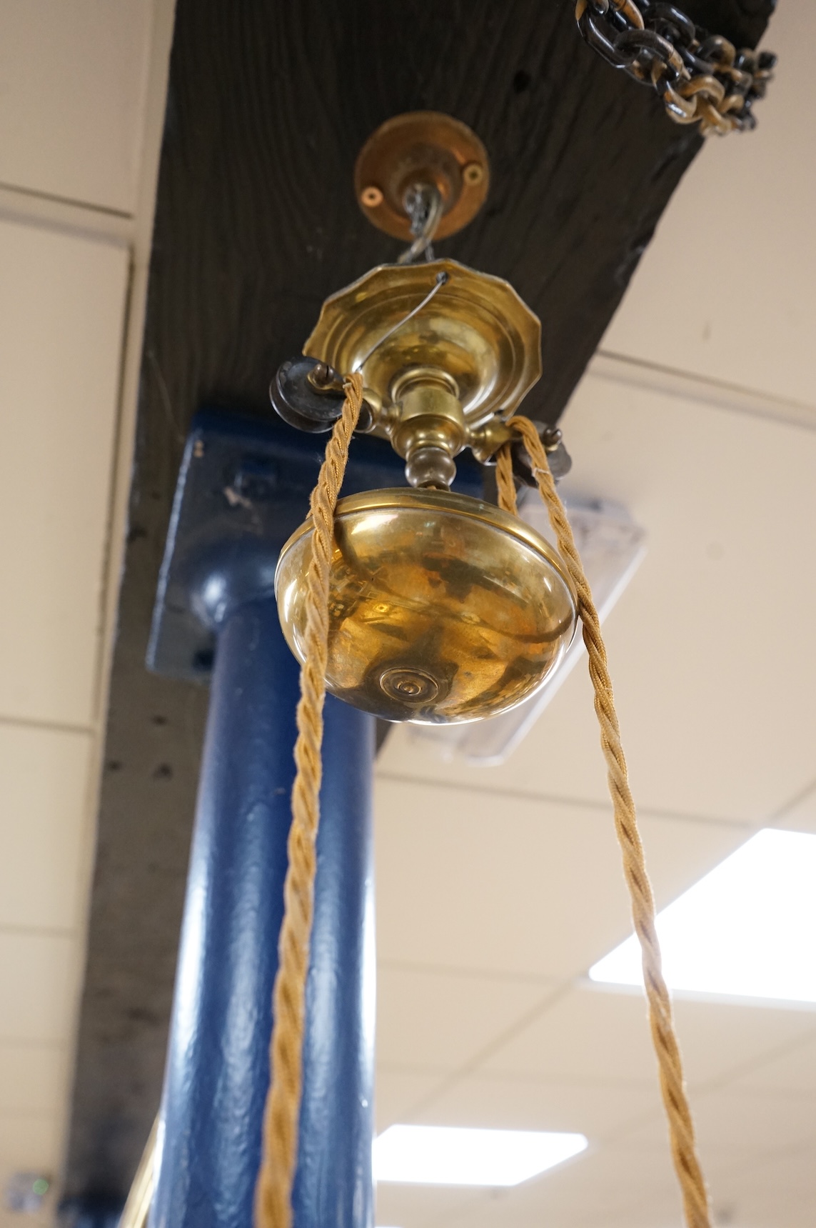 A 19th century brass two branch adjustable ceiling light, with with white glass shades, 82cm full width shade to shade